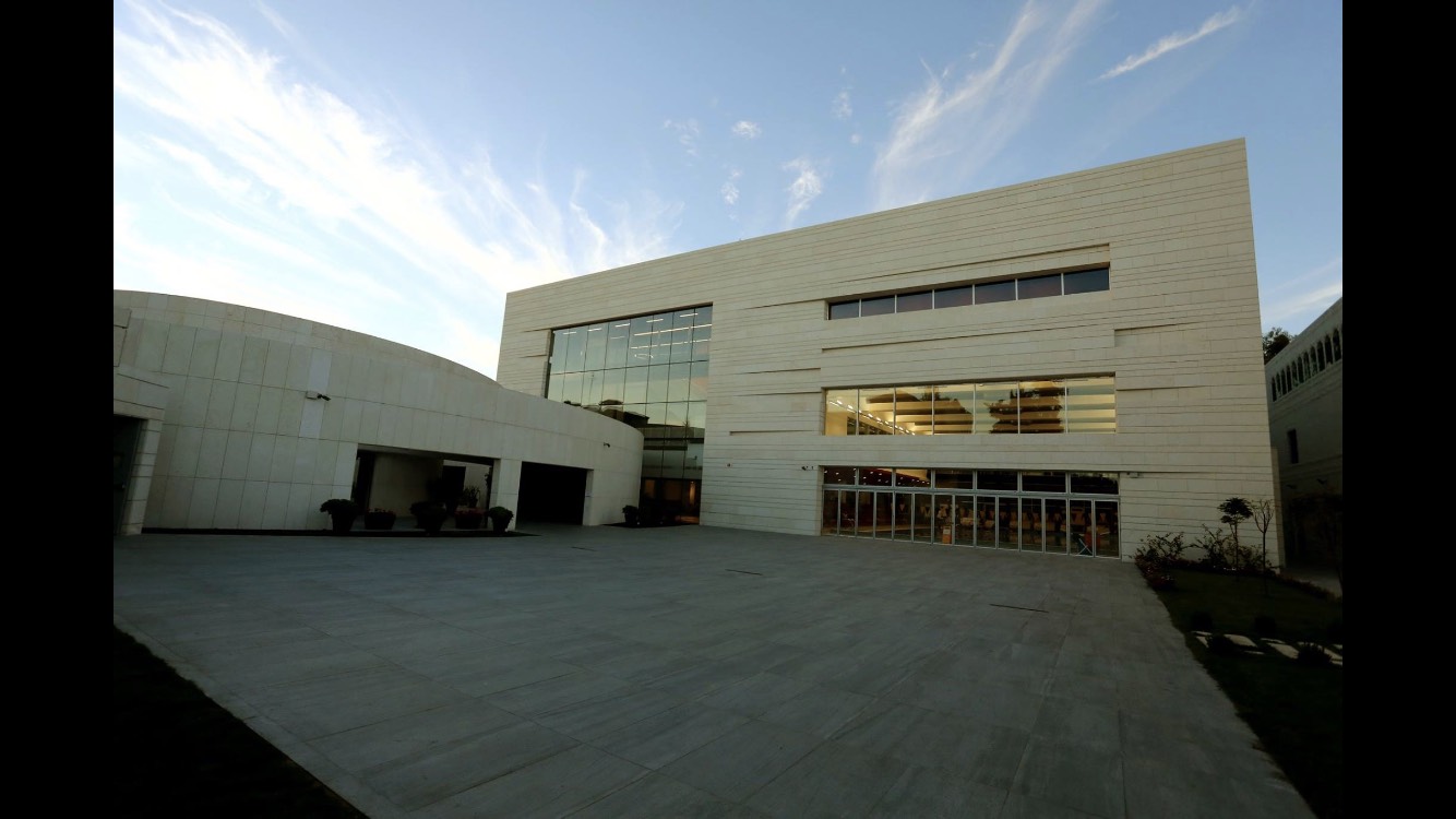 Modern auditorium and campus building at the American Community School