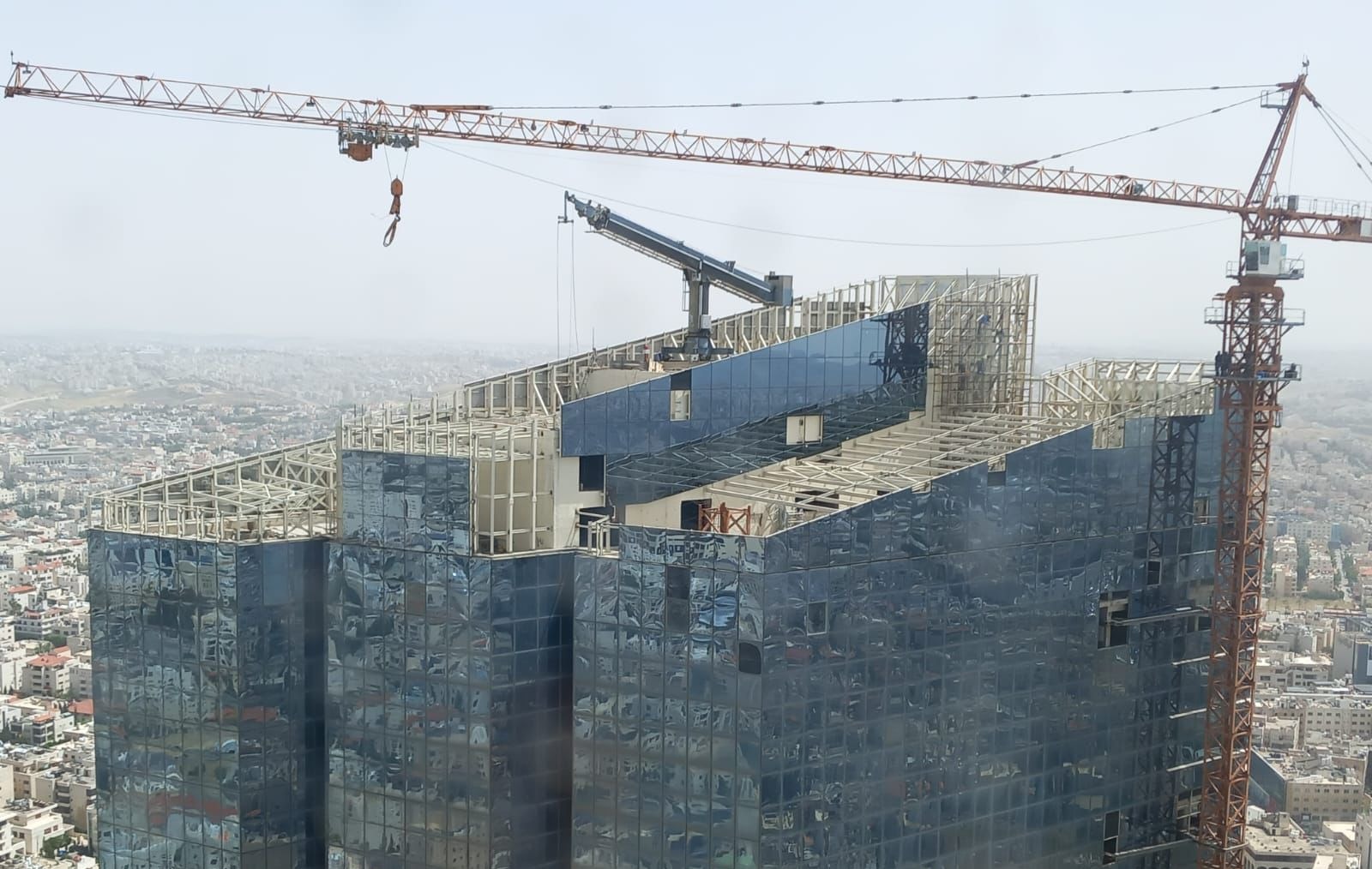Jordan Gate tower under construction with cranes above Amman