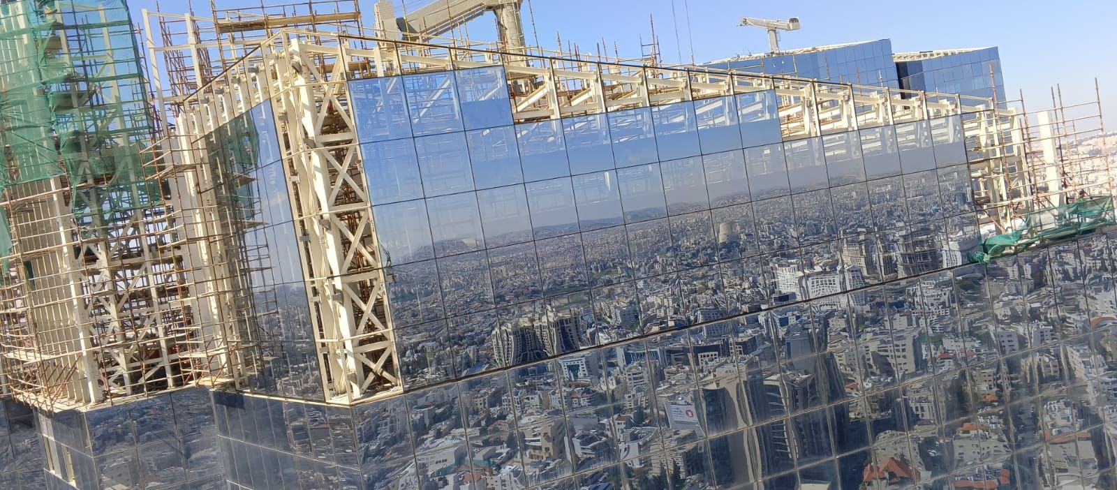 Reflective curtain wall installation at the Jordan Gate towers